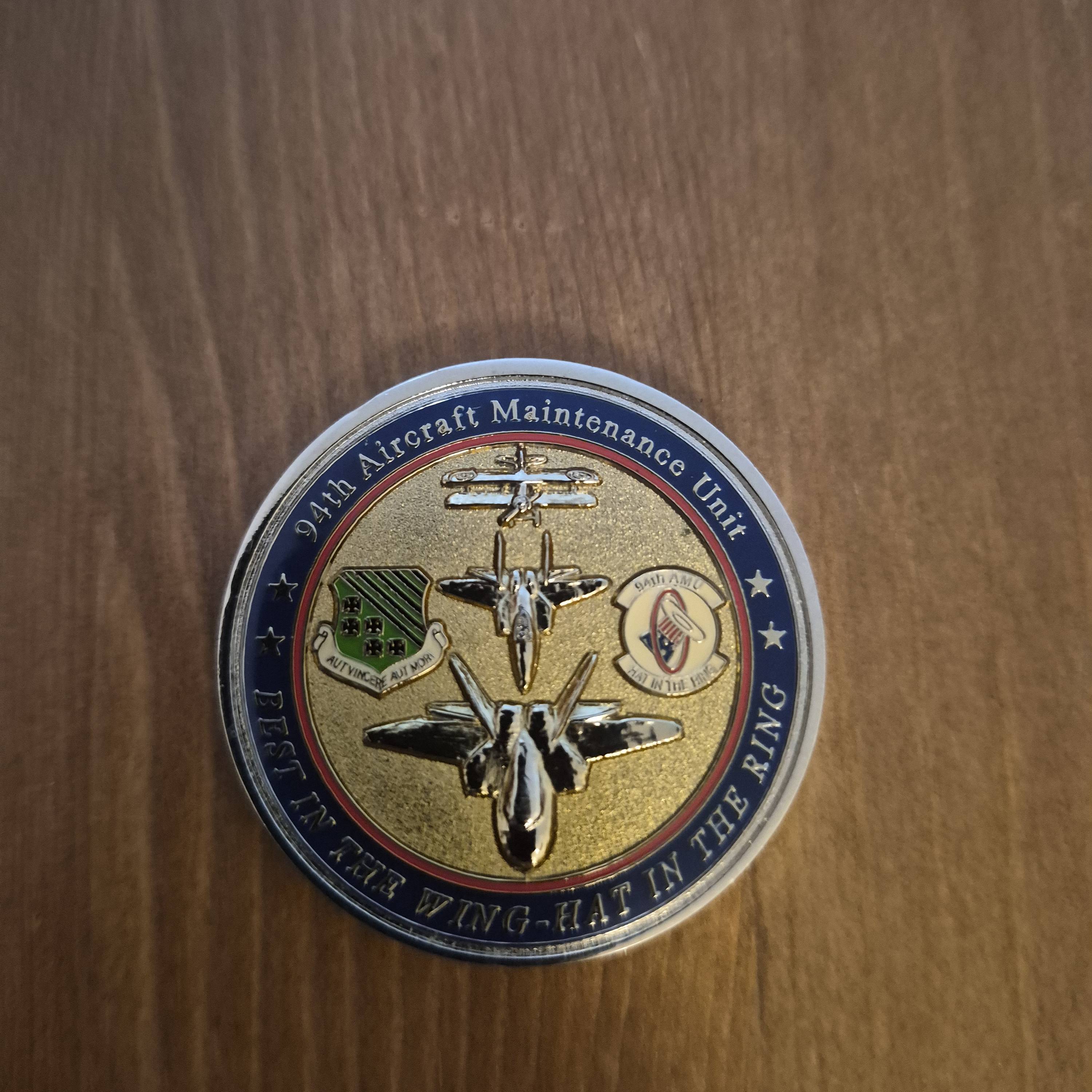 94th AMU challenge coin, hat in the ring — front